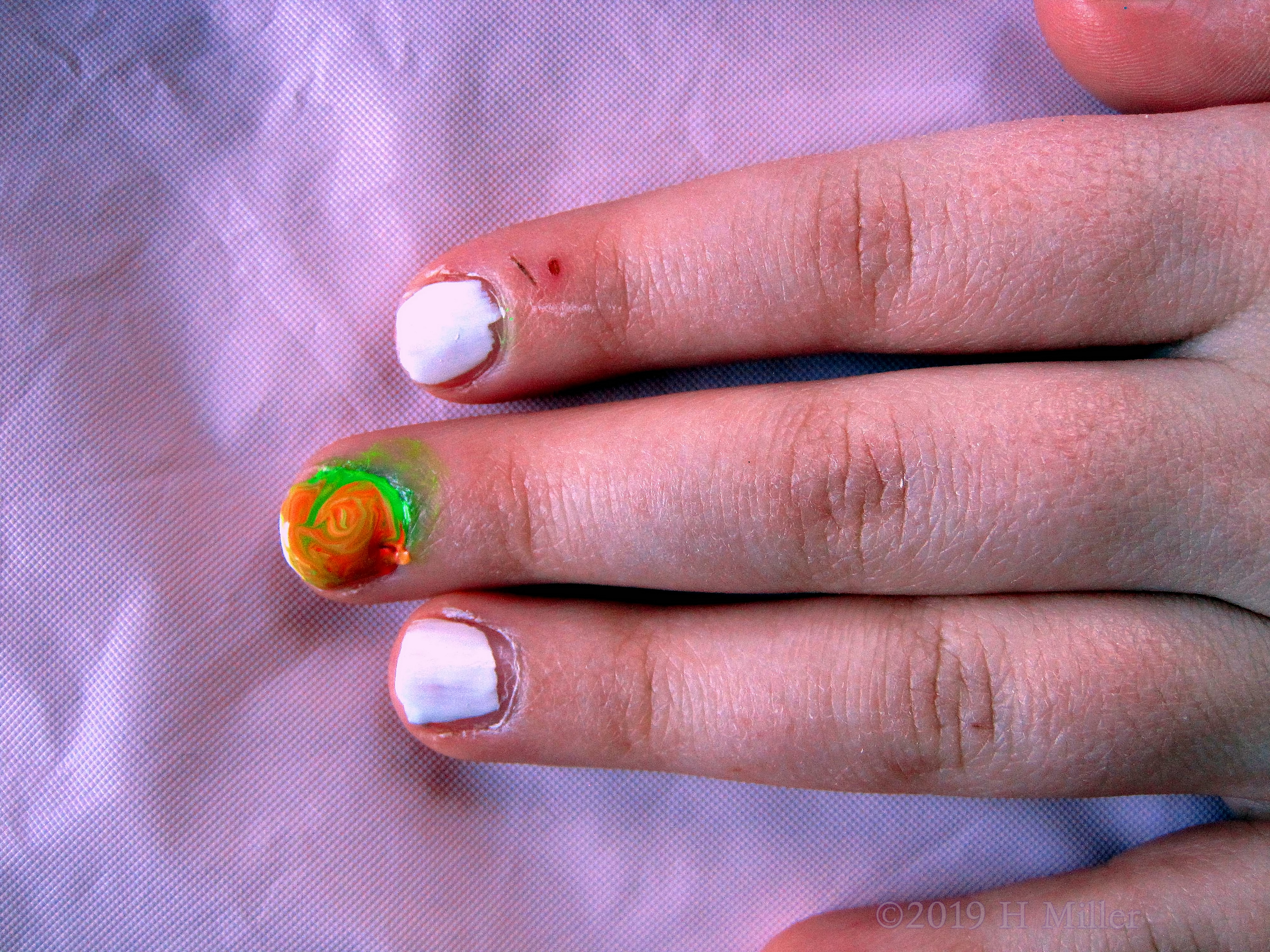 Kids Manicure With White, Plus A Multicolor Marbled Nail Design With Green And Orange Swirls 