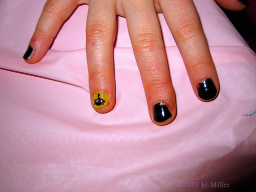 Awesome Kids Manicure With Shimmery Yellow And A Black Spider Nail Art!