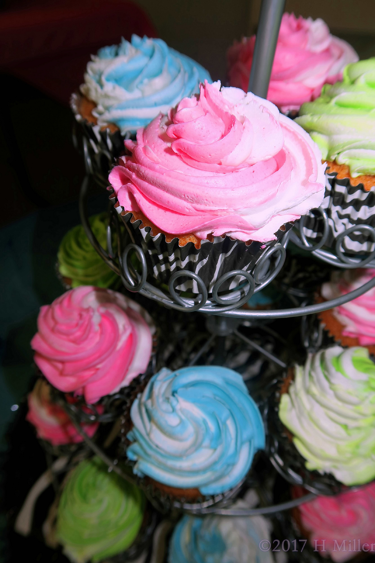 Close Up Of Pink And Blue Iced Rosettes Spa Party Cupcakes. 