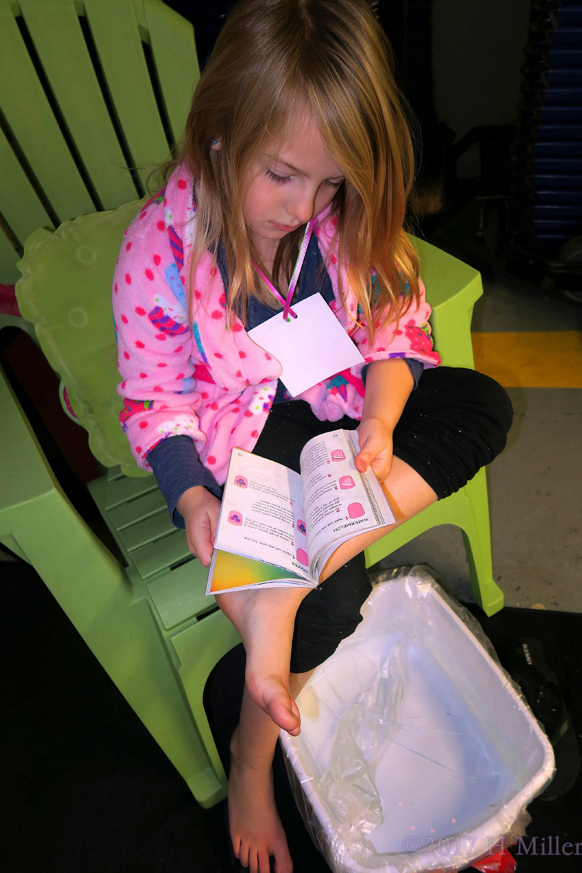 Reading A Fashion Nail Art Book During Kids Pedis 