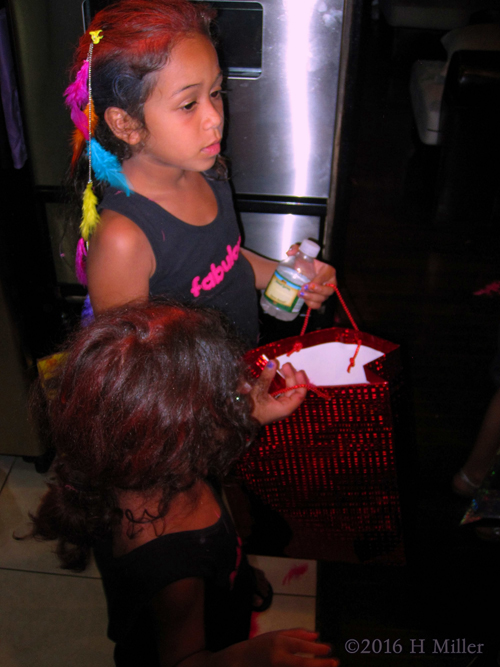 Opening Gifts After Hairstyles At The Kids Party.