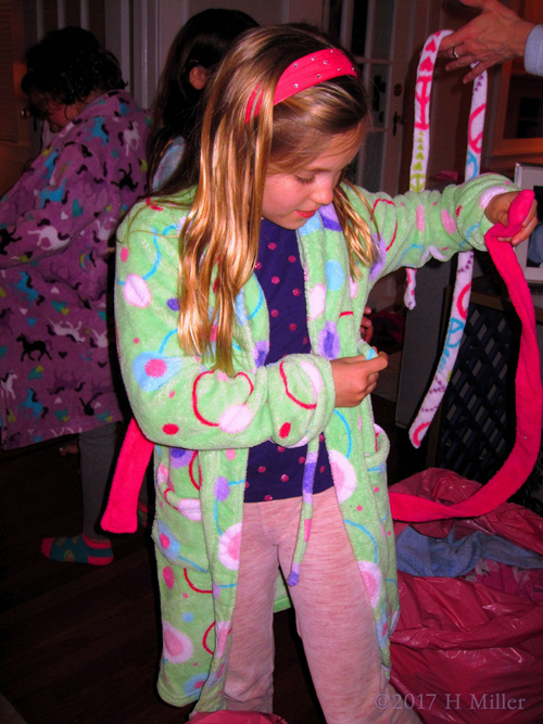 Kids Spa Guest Is Tying The Sash Of Her Spa Robe Kids Spa Guest Is Tying The Sash Of Her Spa Robe