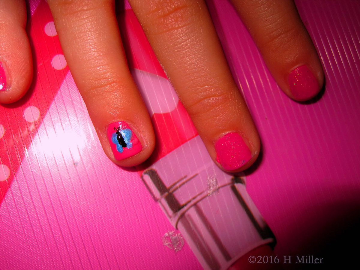 A Cute Nail Design Of A Pretty Blue Butterfly On Pink Background 
