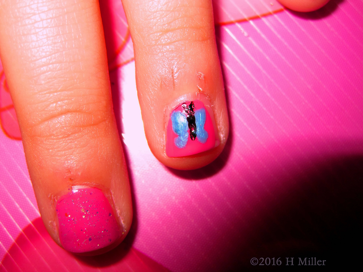 Close Up View Of Pretty Blue Butterfly Nail Art 