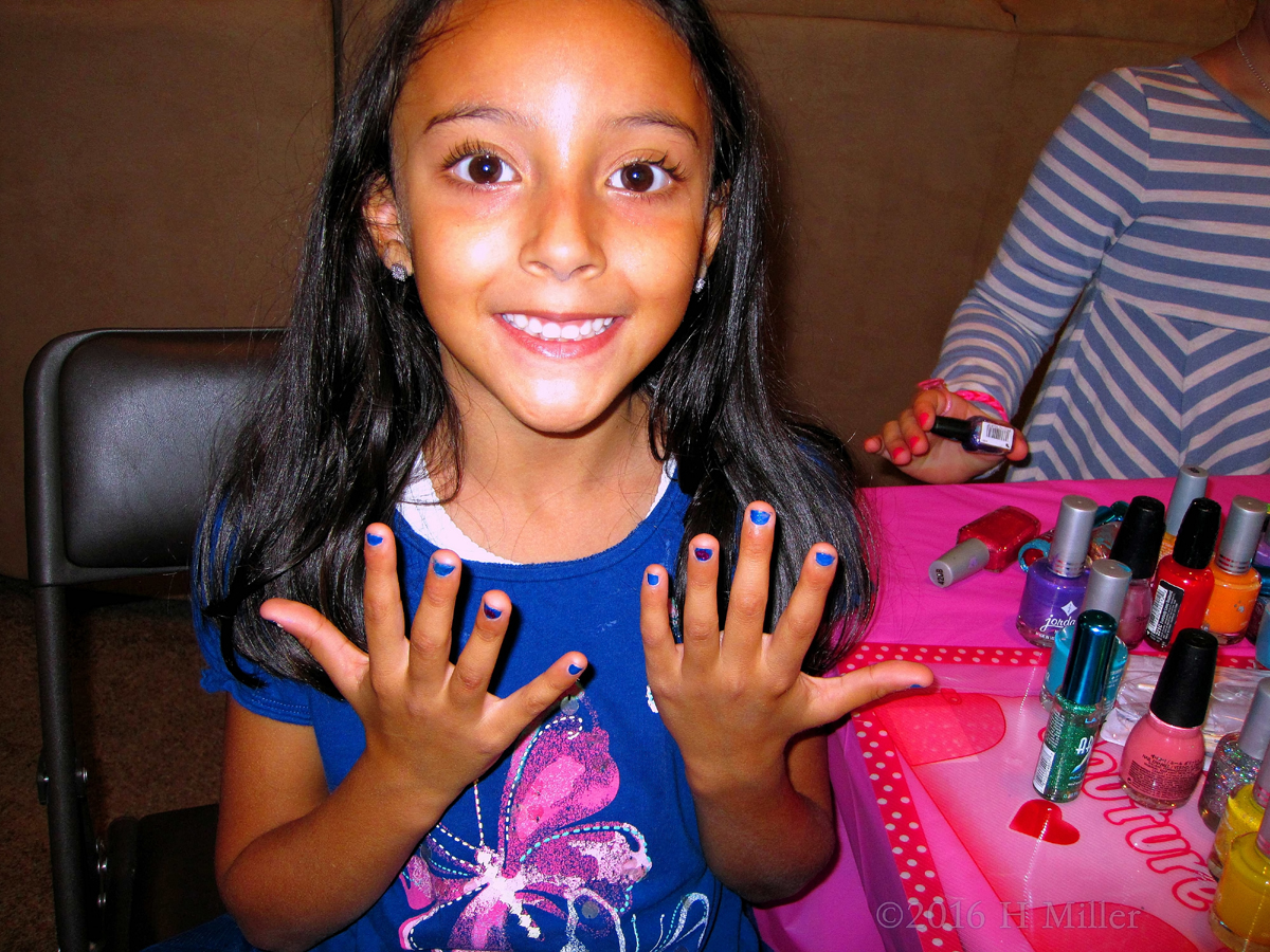 Smiling Guest Shows Off Beautiful Blue Girls Manicure 