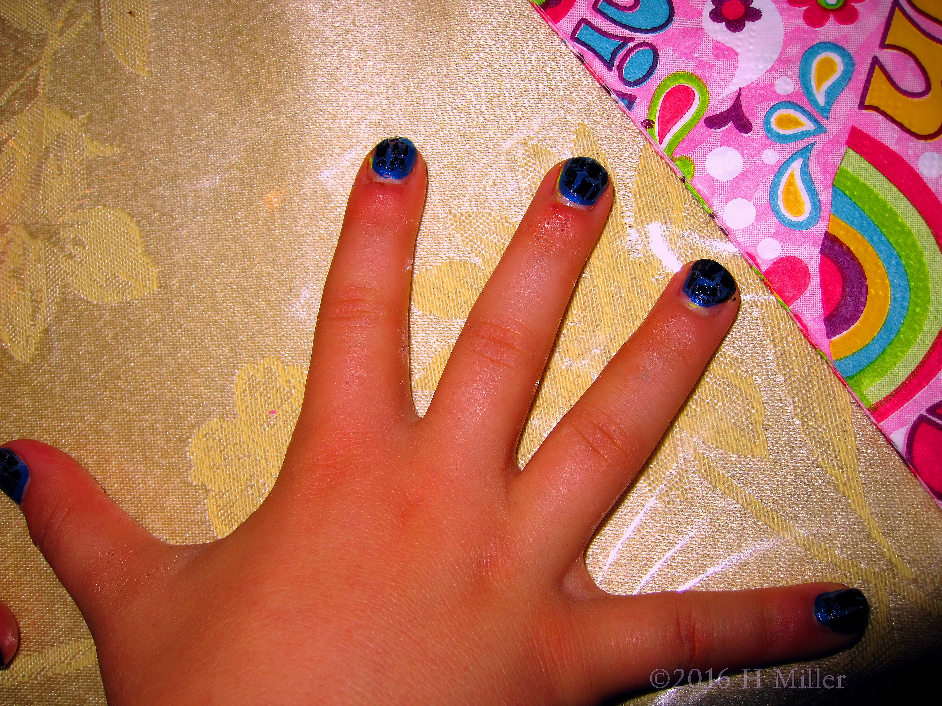 Kids Manicure Features Black Shatter With Blue Background 