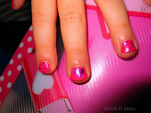 Kids Manicure With Nail Design Of A Purple Heart On A Pink Backgroun