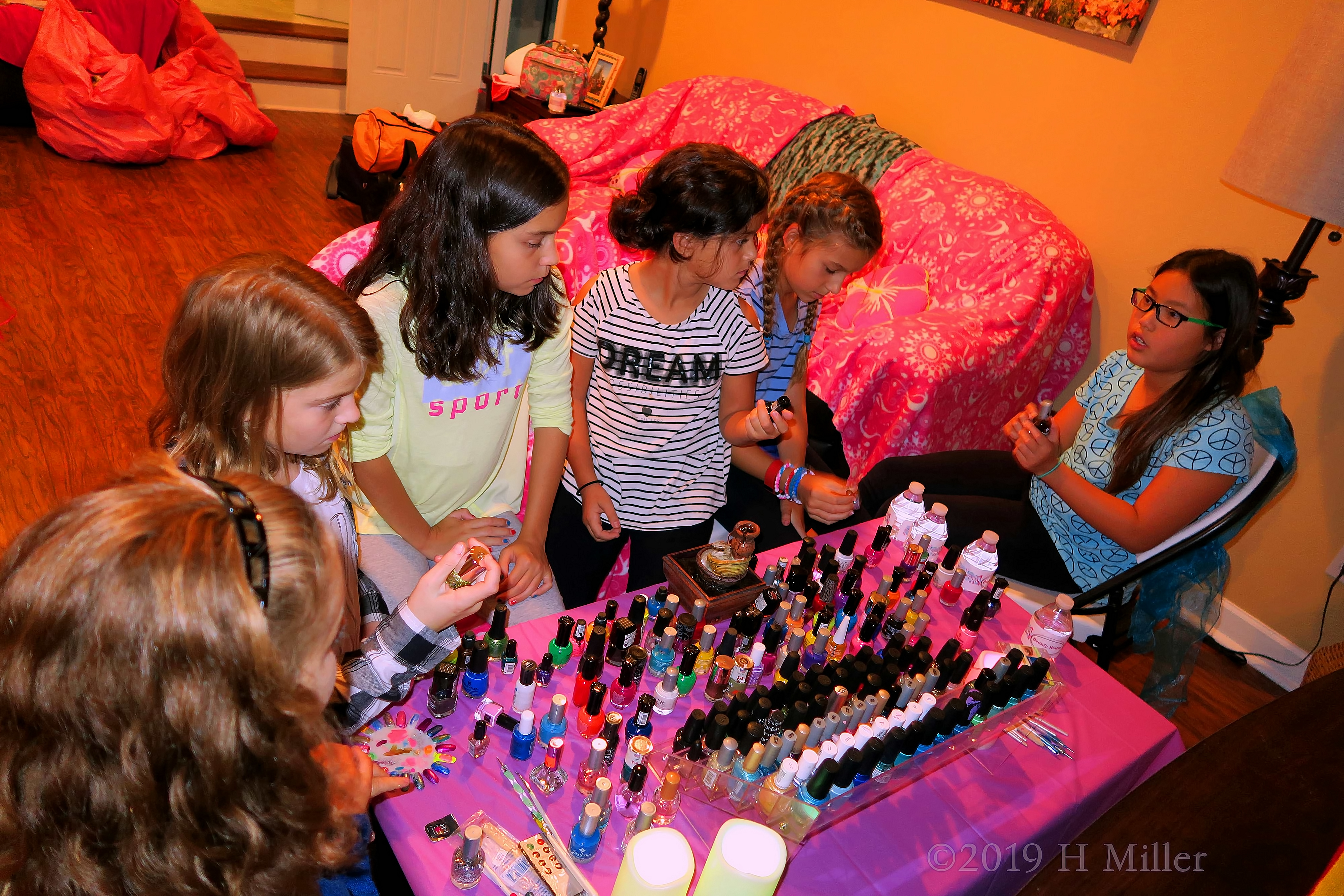 Guests Chilling At Nail Art Station With Pink Spa Throws In The Backdrop 