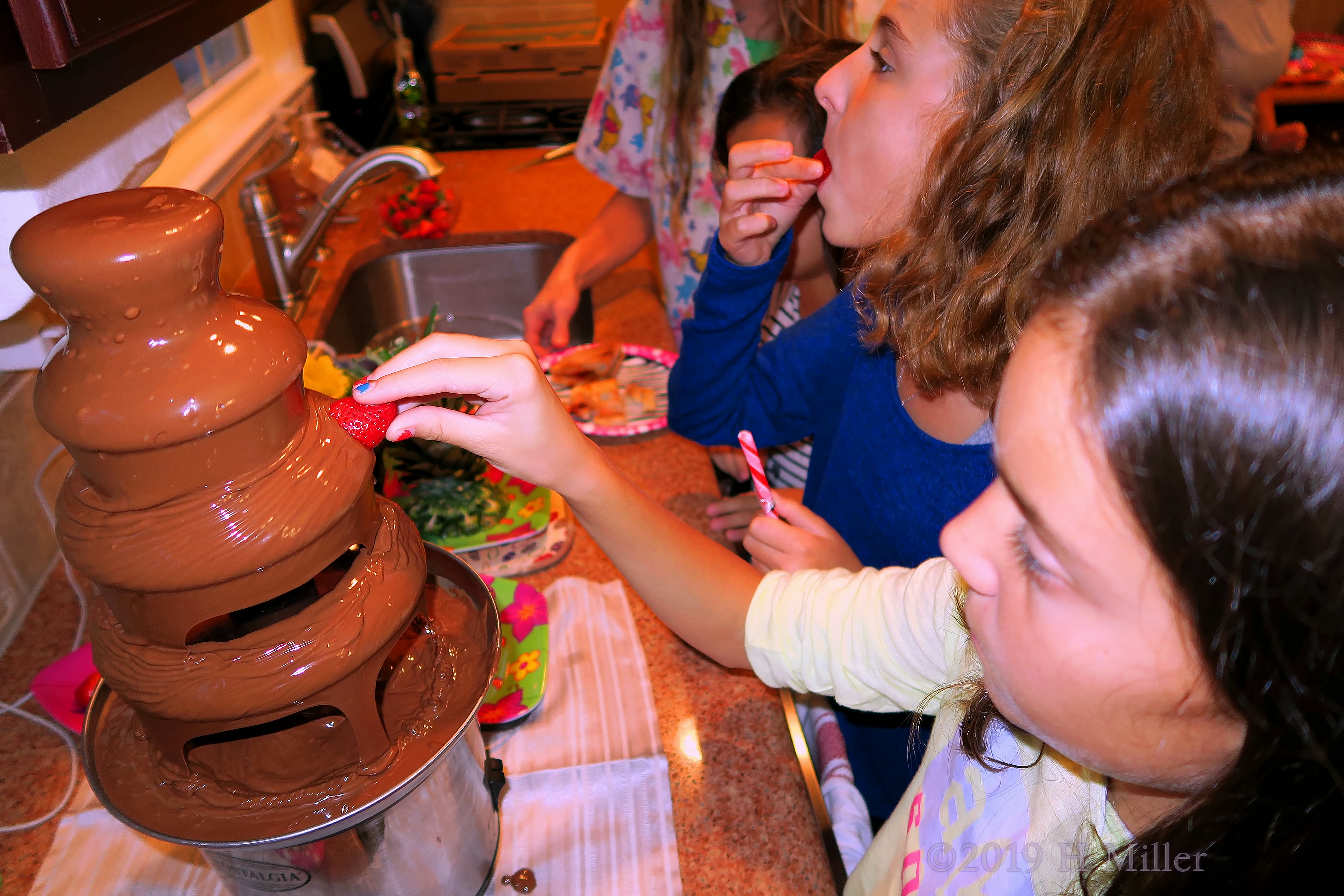 Party Guest Having Fun At The Chocolate Fountain 