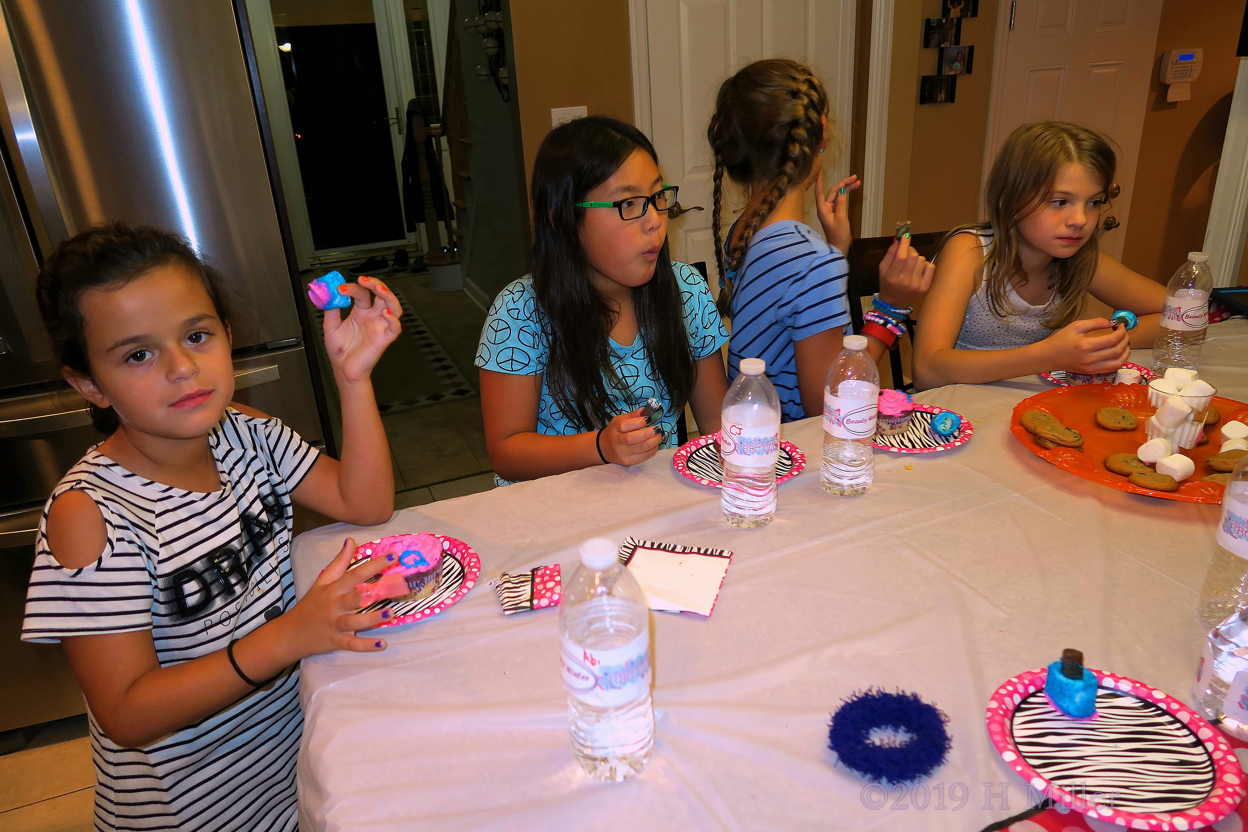 Party Guests Enjoying Birthday Cupcakes 