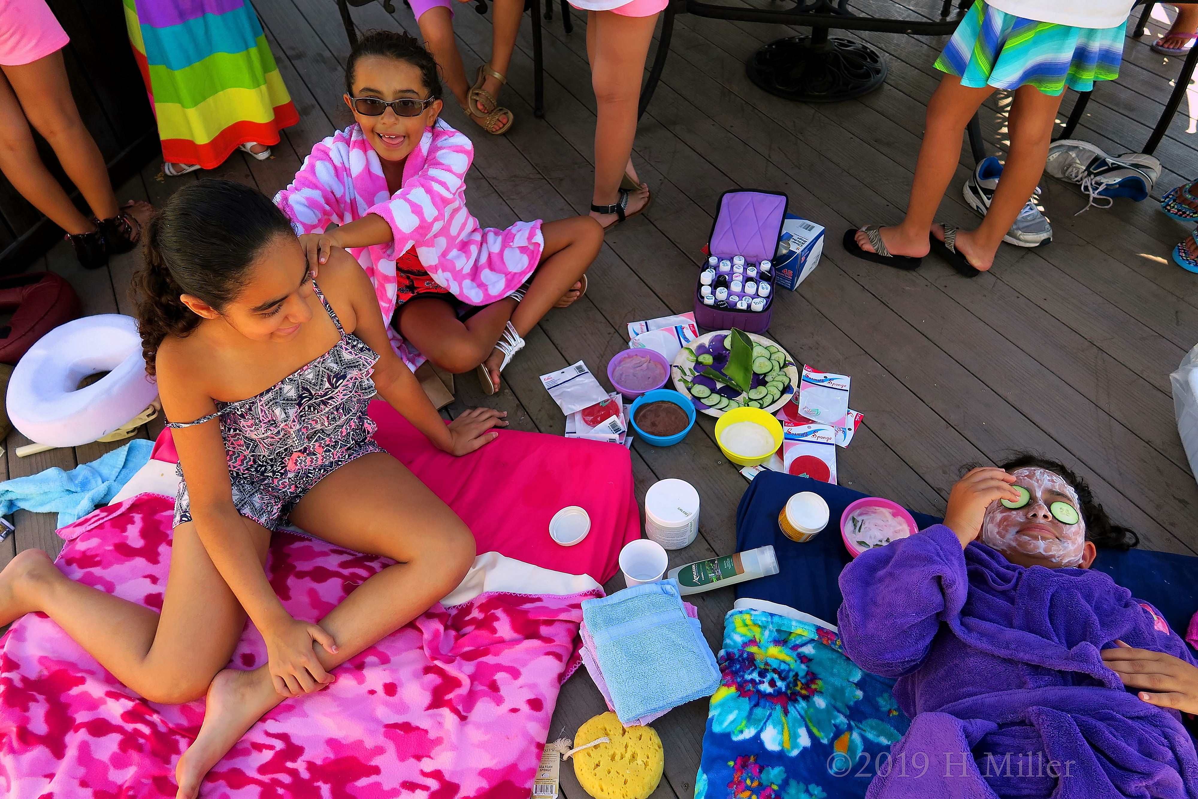 Birthday Girl Looking On At Her Friend Enjoying Her Kids Facial Birthday Girl Looking On At Her Friend Enjoying Her Kids Facial