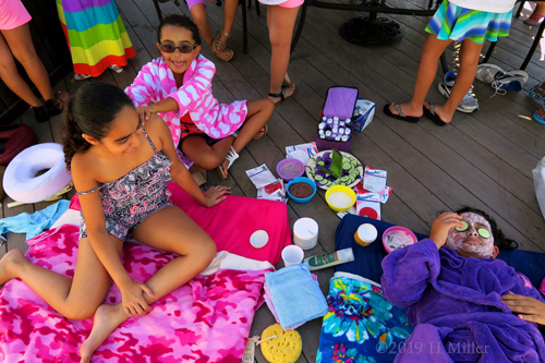 Birthday Girl Looking On At Her Friend Enjoying Her Kids Facial Birthday Girl Looking On At Her Friend Enjoying Her Kids Facial