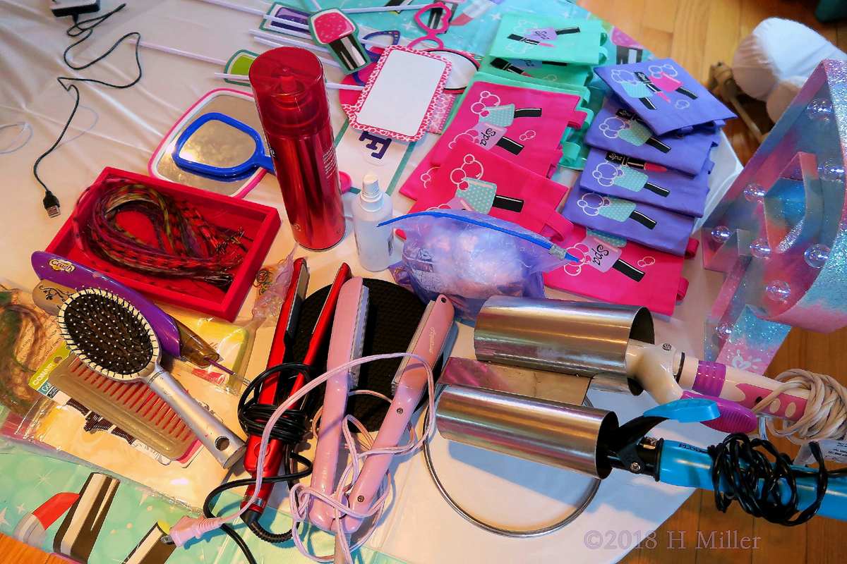 Collection Of Hair Straighteners, Combs, And Curling Irons For The Girls Hairstyling Activity! 