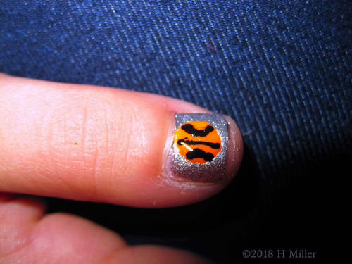 Close Up Of The Basketball Nail Design On Silver Polish. Close Up Of The Basketball Nail Design On Silver Polish.