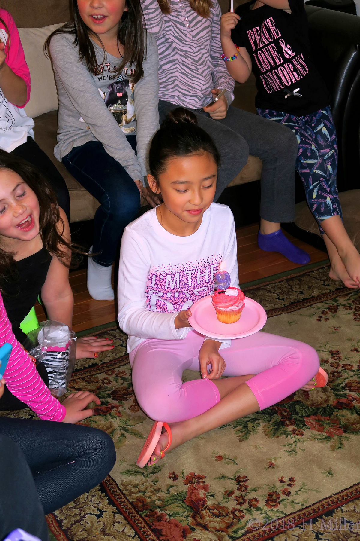 Birthday Girl Making A Wish On Her Cupcake 