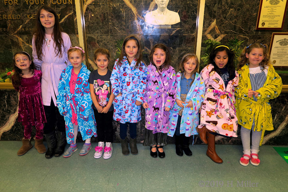 Party Guests Posing In Their Comfy Spa Robes 