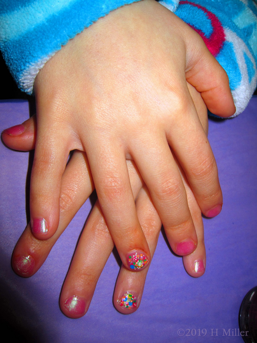 Blush Pink Nail Coat With Rainbow Sparkled Accent Nail For This Neat Kids Spa Manicure