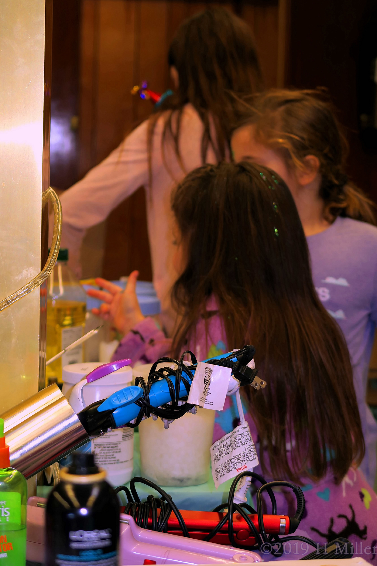 Close Up Of Hair Styling Equipment With Cozy Guests In The Background 