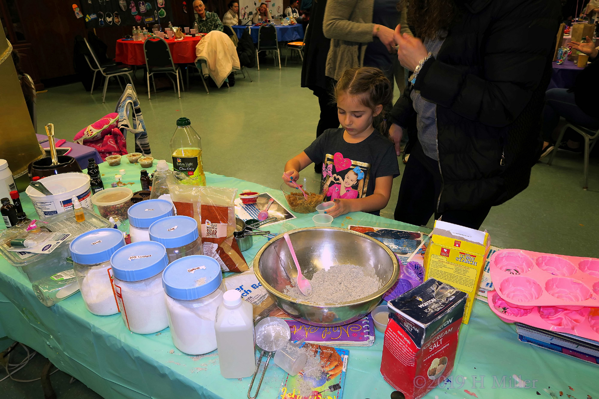 Close Up Of Kids Craft Station With Party Guest Getting Her Crafts Made 