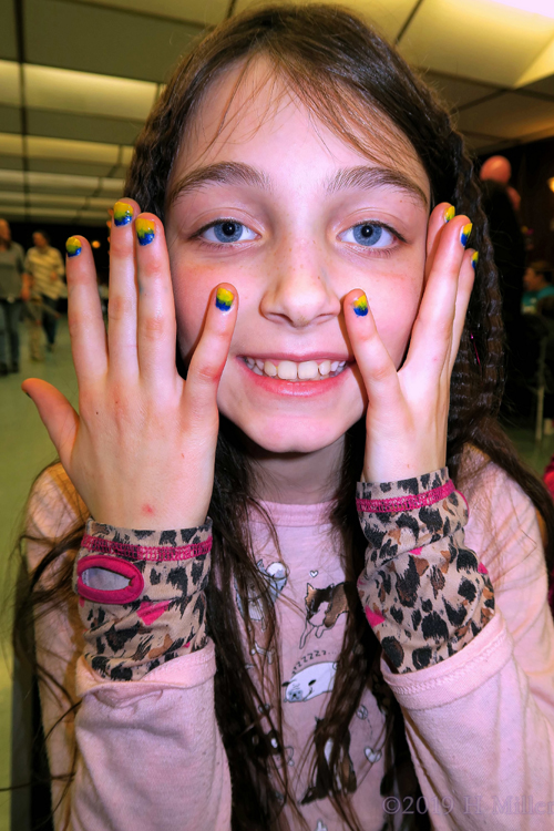 Showing Off Her Kids Mini Mani With Blue And Yellow Ombre Nail Design