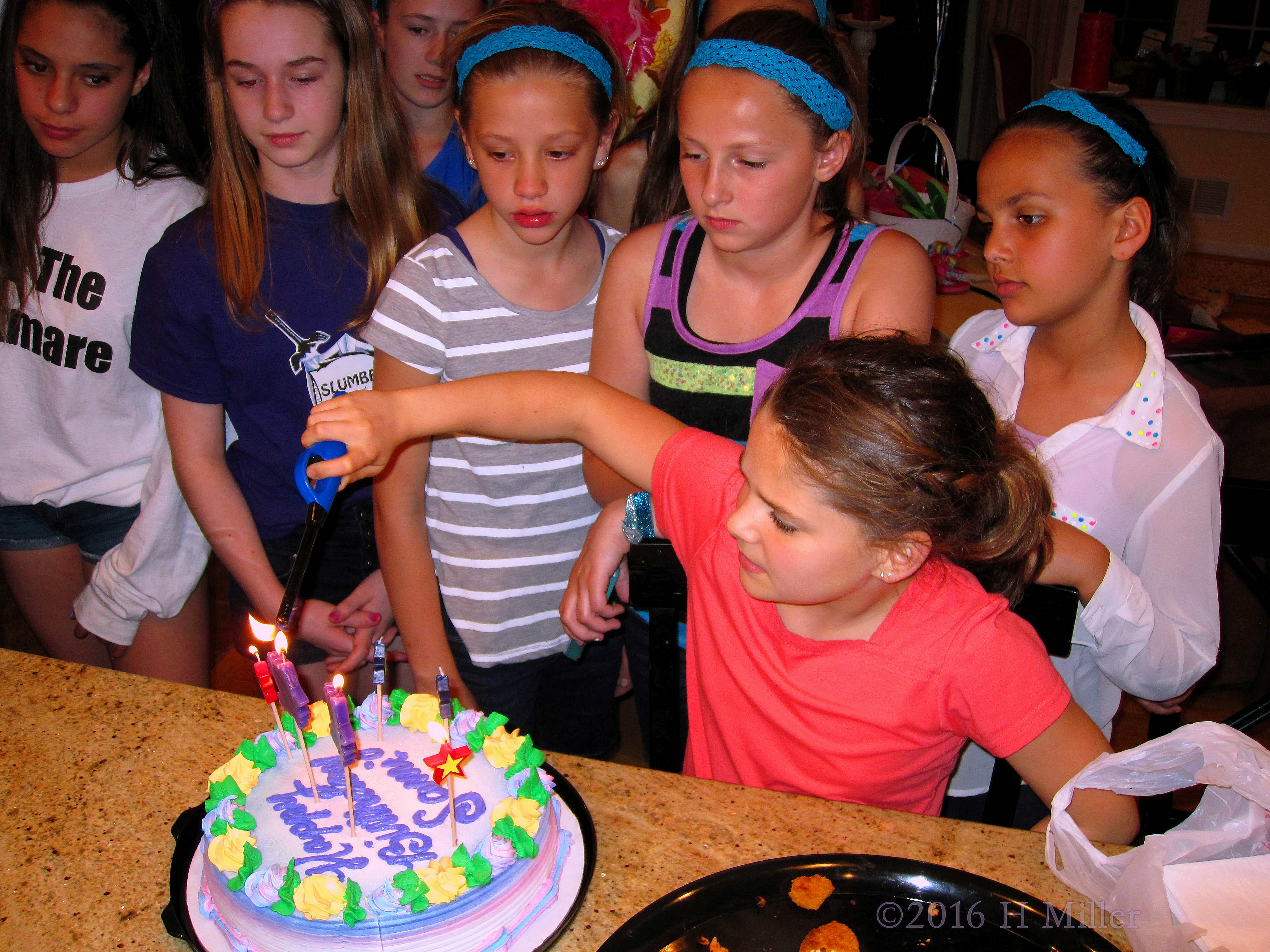 Lighting Some More Of The Birthday Candles While Her Friends Await. 