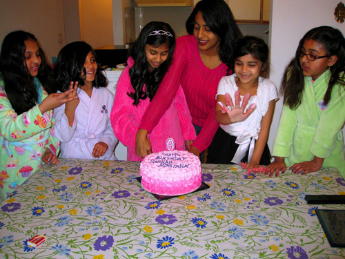 The Girls Showing Their Nails For The Camera As The Cake Is Cut.