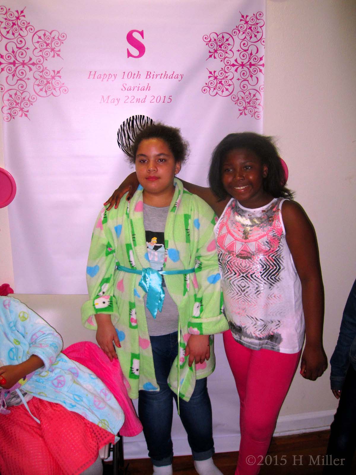 A Closer Pic Of The Birthday Girl And Her Friend In Front Of The Banner 