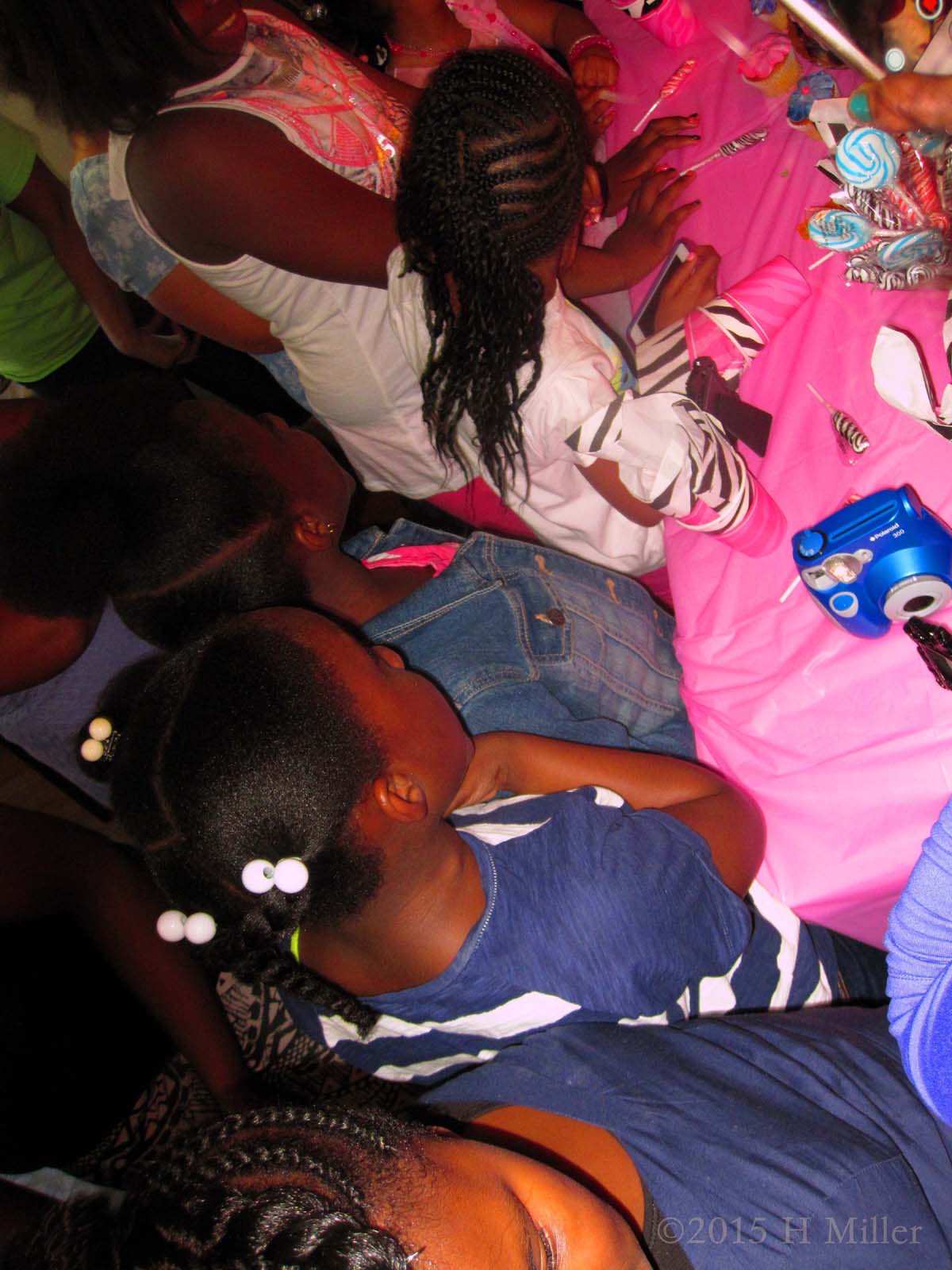 Blowing Out The Candles On Her Birthday Cake At The Kids Spa Party 