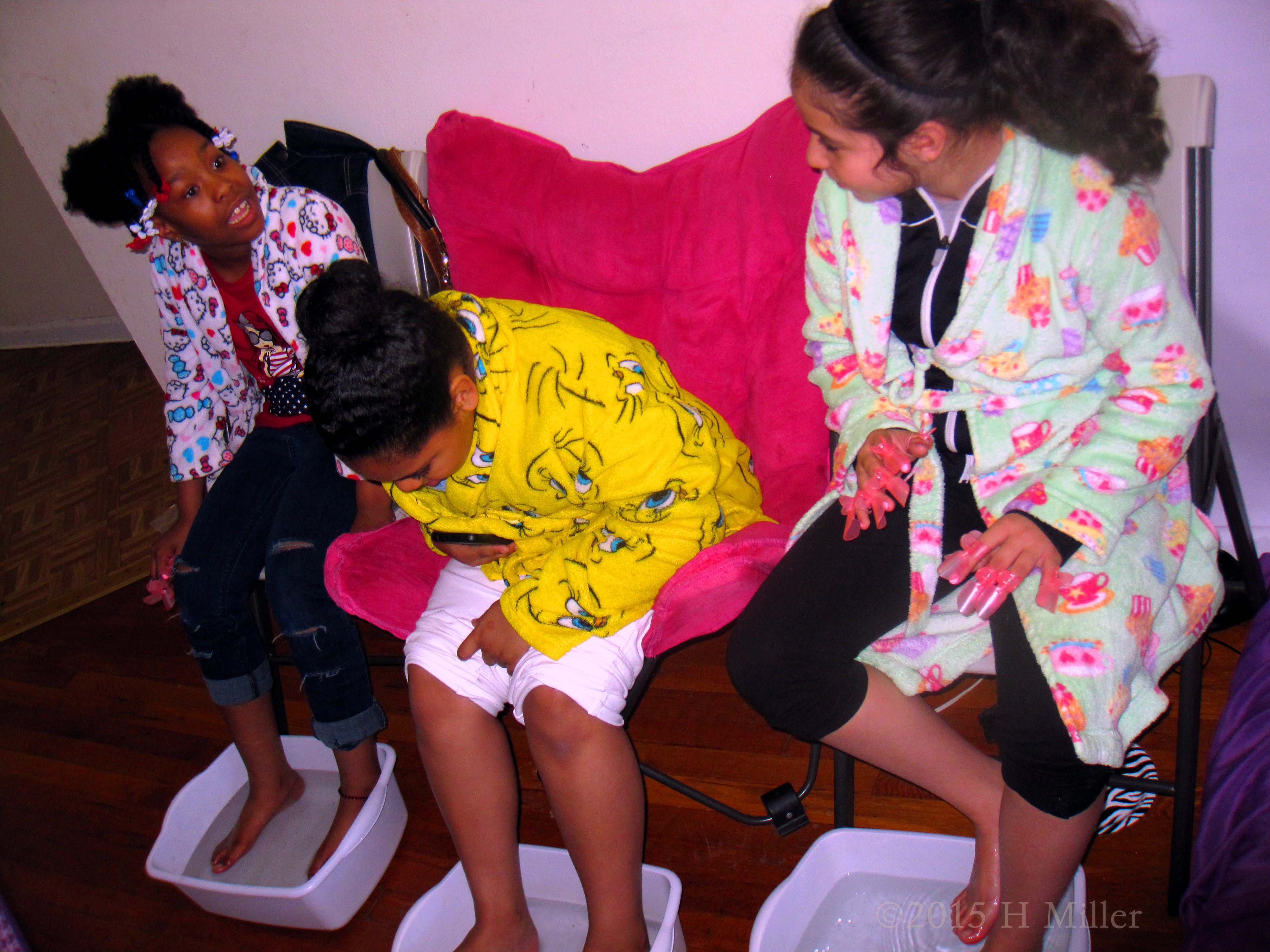 Stirring The Footbath And Curiously Looking At The Water Which Just Had Essential Oils Added Stirring The Footbath And Curiously Looking At The Water Which Just Had Essential Oils Added