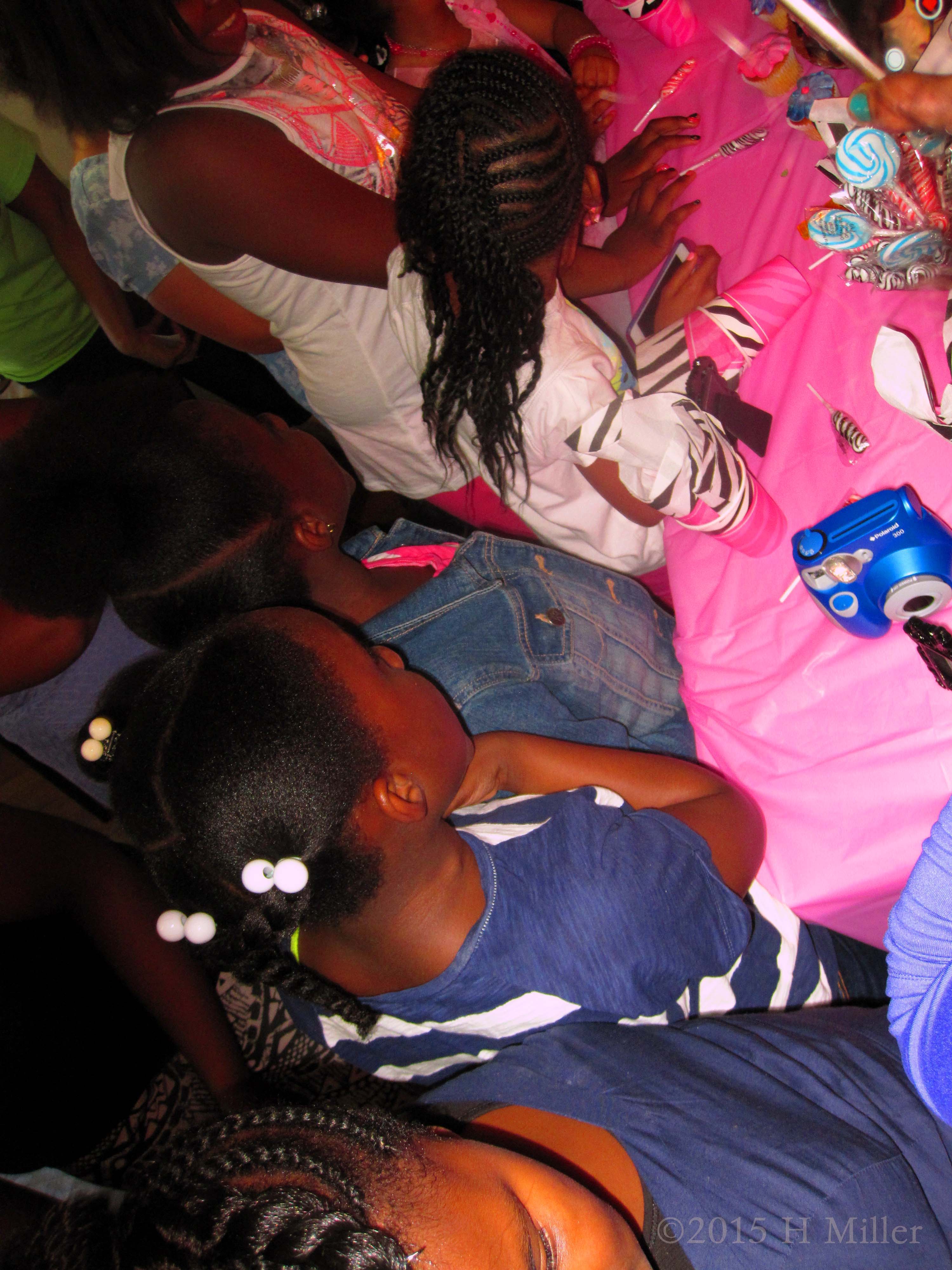Blowing Out The Candles On Her Birthday Cake At The Kids Spa Party 