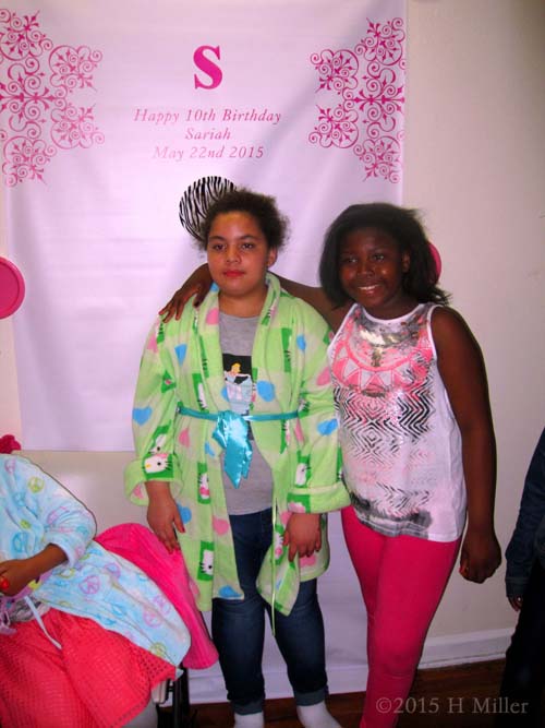 A Closer Pic Of The Birthday Girl And Her Friend In Front Of The Banner