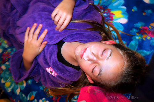 Party Guest Relaxing While Applying Her Kids Facial