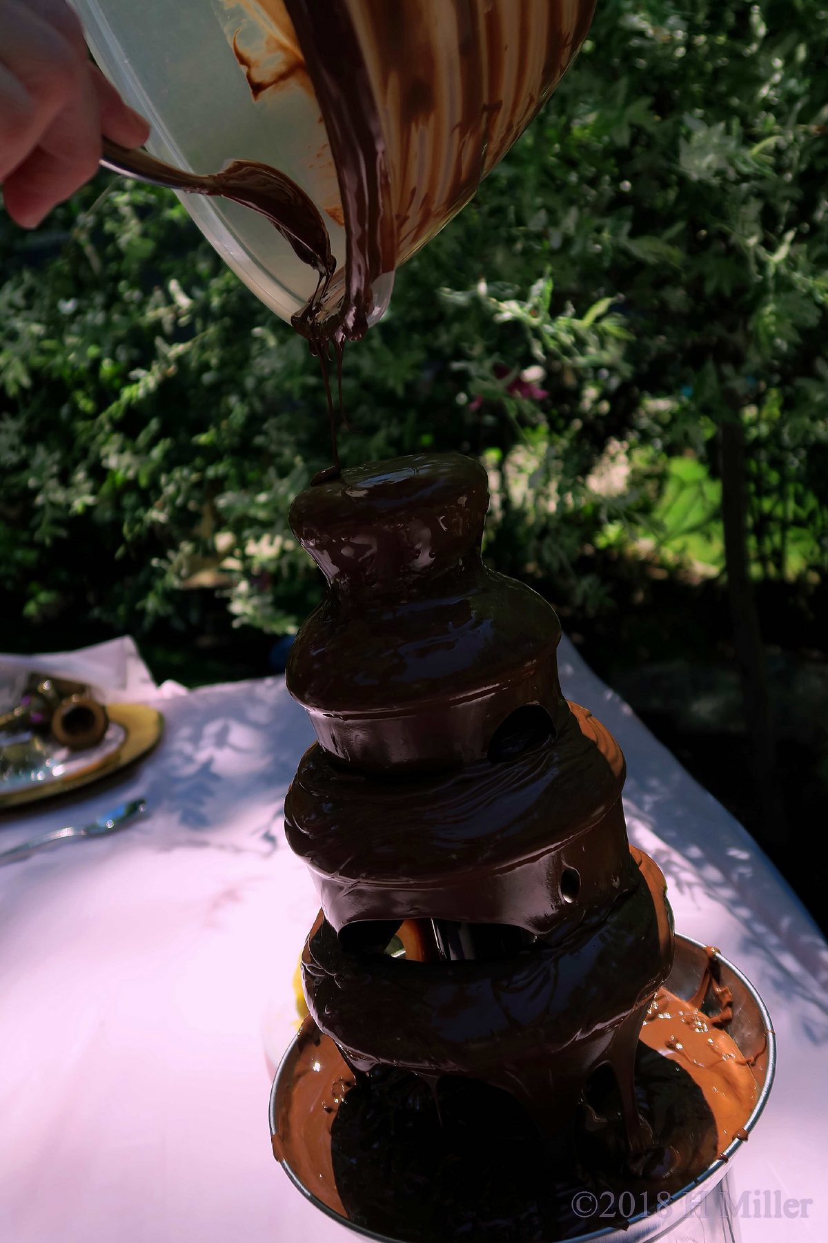 Scooping Chocolate Onto The Chocolate Fountain 
