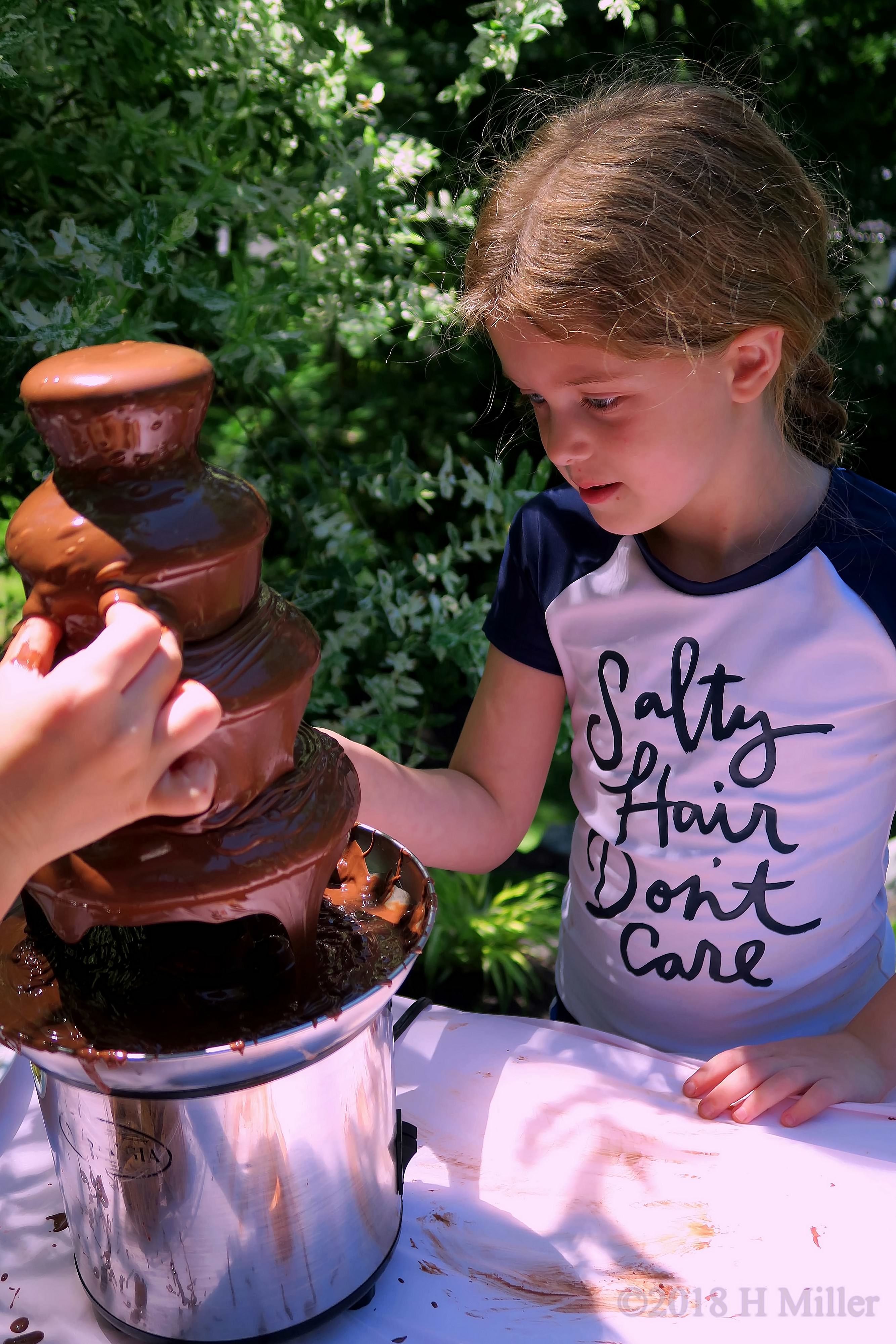 Excitedly Eating Chocolate From The Chocolate Fountain 