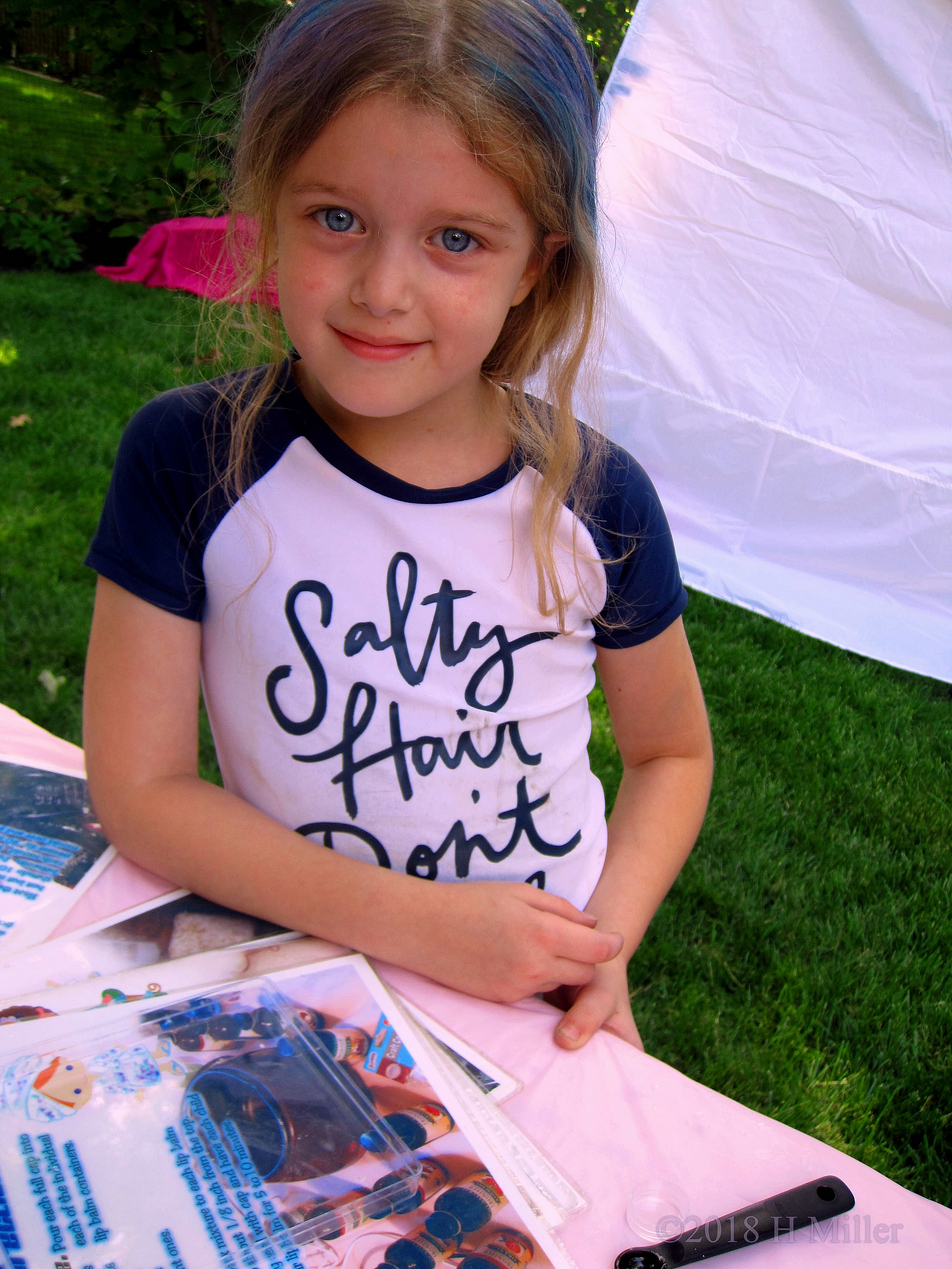 Party Guest Making Lip Balm Kids Crafts While Smiling At The Camera!