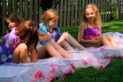 Birthday Guests Chatting Over Colors During Kids Pedicures 