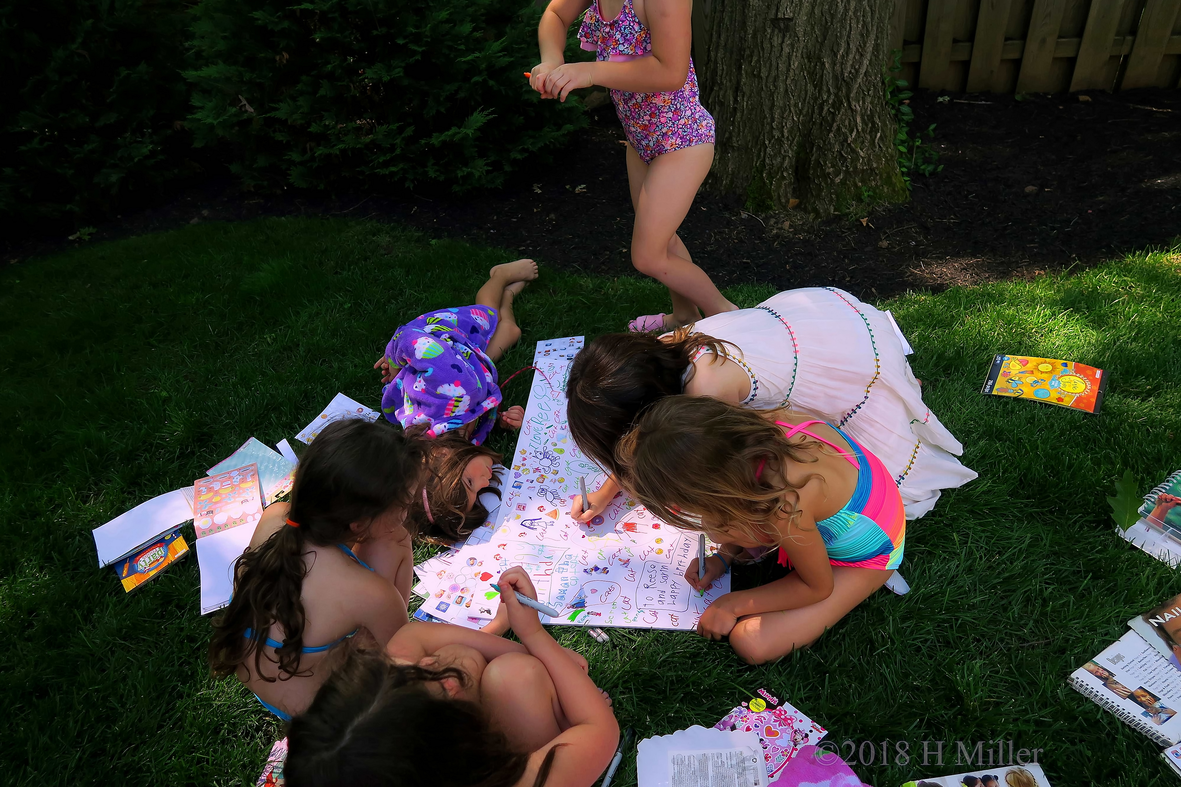 Party Guests Using Markers And Stickers To Decorate The Spa Birthday Card 