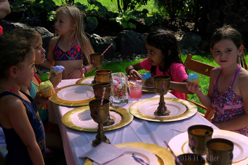Birthday Guests Enjoying Birthday Cupcakes Birthday Guests Enjoying Birthday Cupcakes