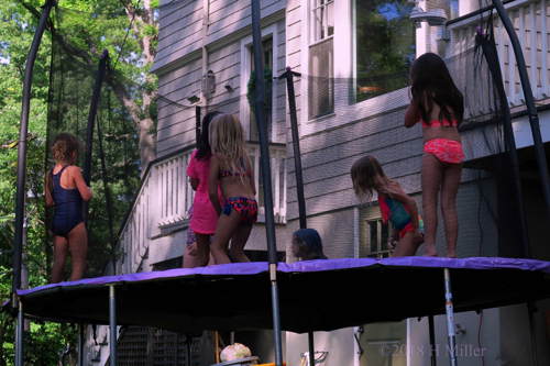 Party Guests Jumping On The Trampoline 