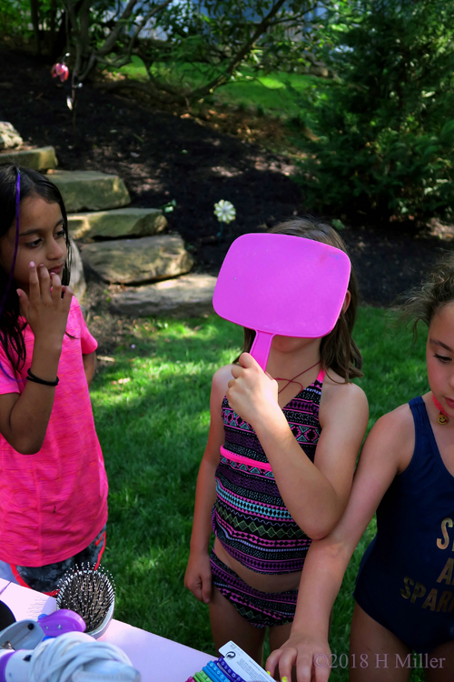 Spa Party Guest Using The Mirror To Check Her Hair Feather Spa Party Guest Using The Mirror To Check Her Hair Feather
