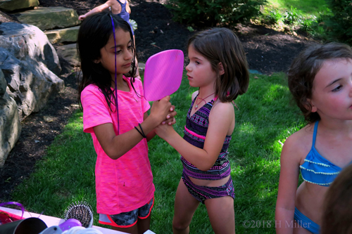 Spa Party Guests Checking Hair Feathers In Mirror 