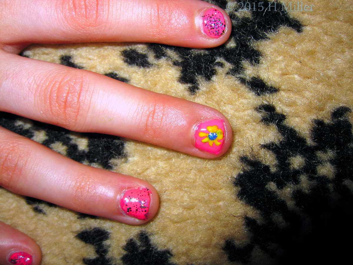 Closeup Of Nail Art Blue And Yellow Ray Flower.