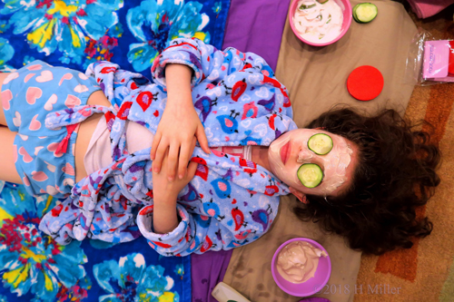 Party Guest Enjoying Her Spa Facial Complete With Cucumber Slices Party Guest Enjoying Her Spa Facial Complete With Cucumber Slices