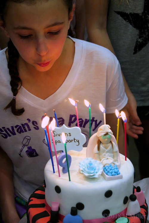Sivan Blowing Out Her Candles On Her Birthday Cake 
