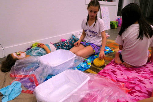 Birthday Girl Taking The Time To Help Her Guest Be Pampered With A Kids Facial Birthday Girl Taking The Time To Help Her Guest Be Pampered With A Kids Facial