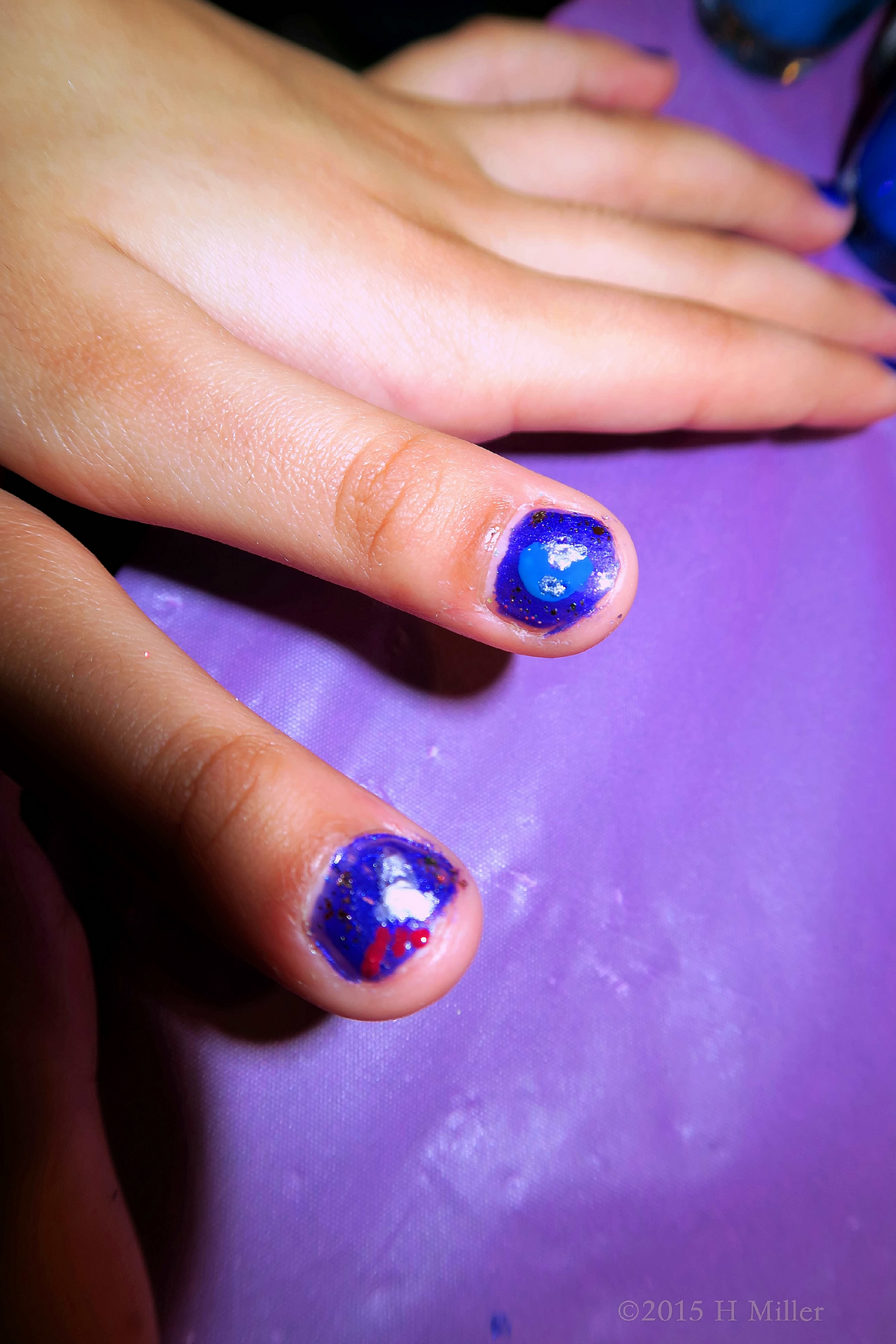 A Rocket. The Planet Earth. All On A Kid's Nails!! lol 
