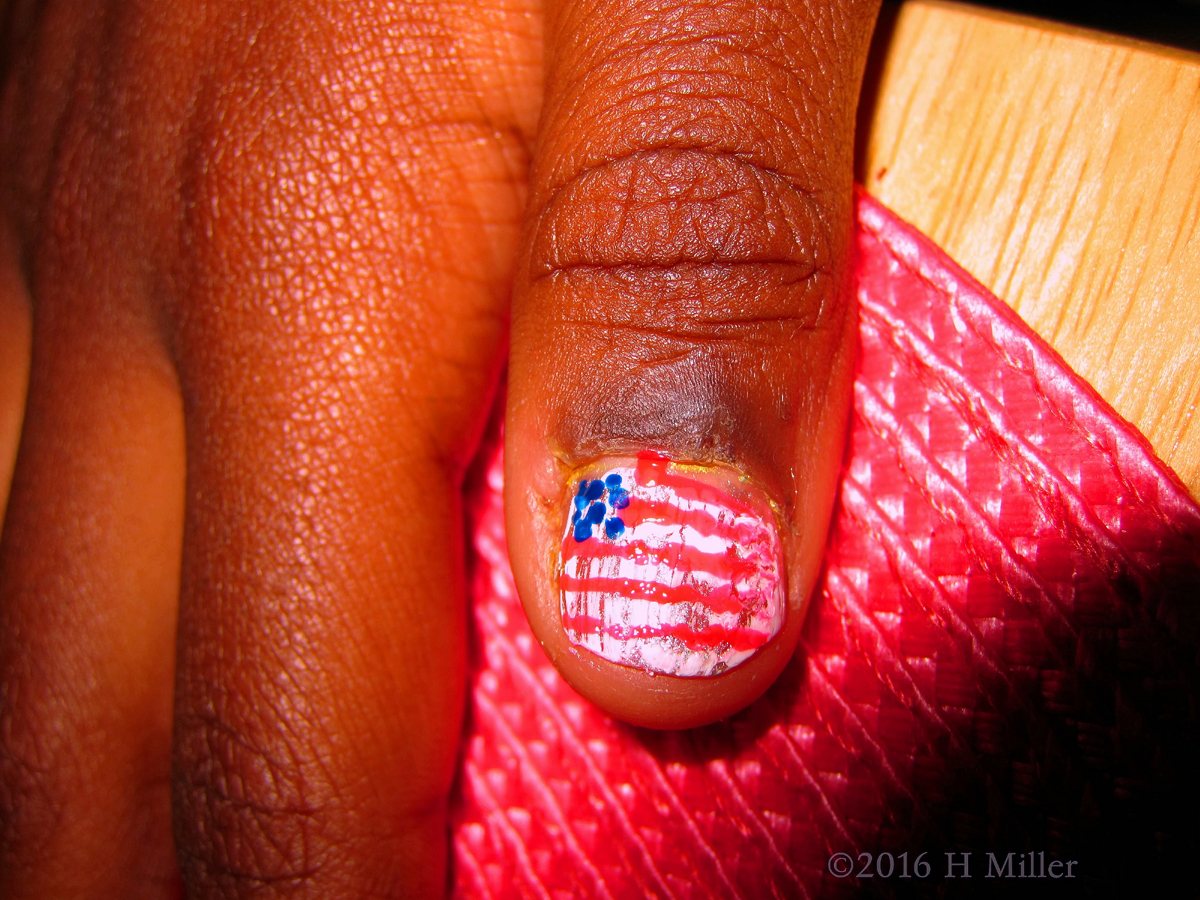 Close Up Of Accent Nail Design Replicating The Starts And Stripes Of The American Flag 