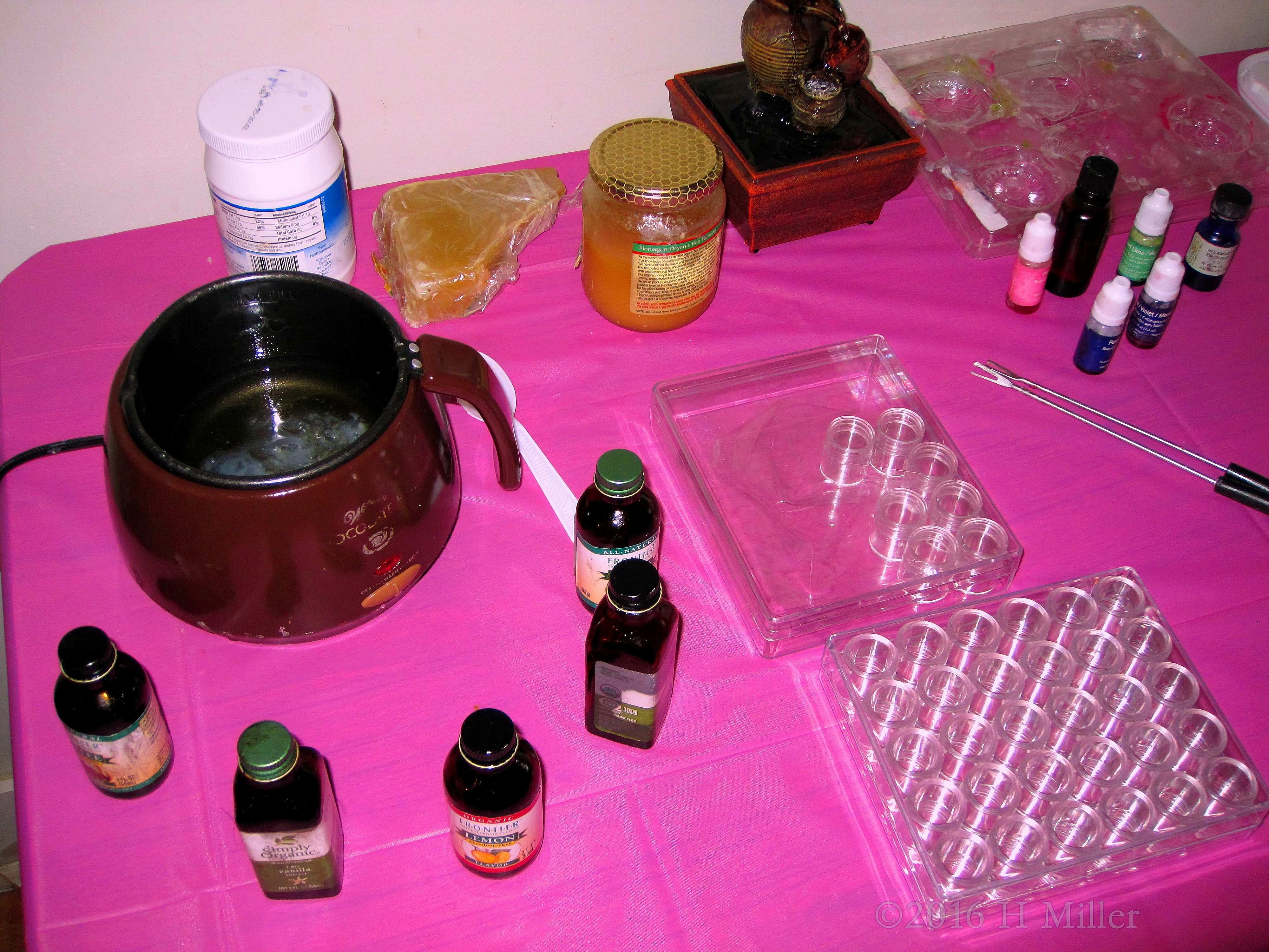 Close Up Of Kids Craft Station Showcasing Lip Gloss Containers And Ingredients 