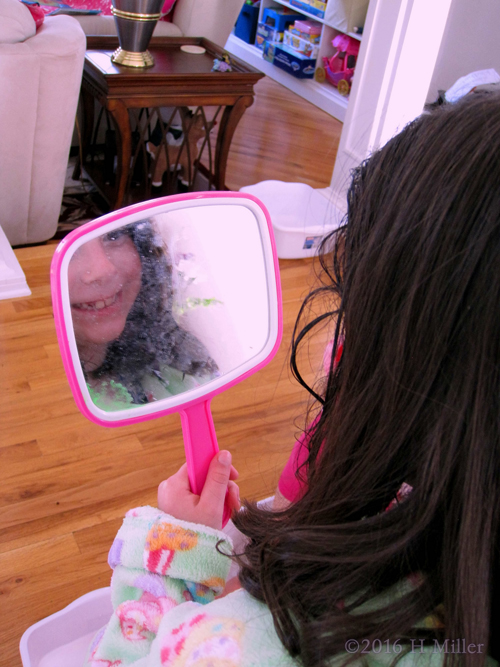 Checking Out Her Kids Hairstyle In The Mirror