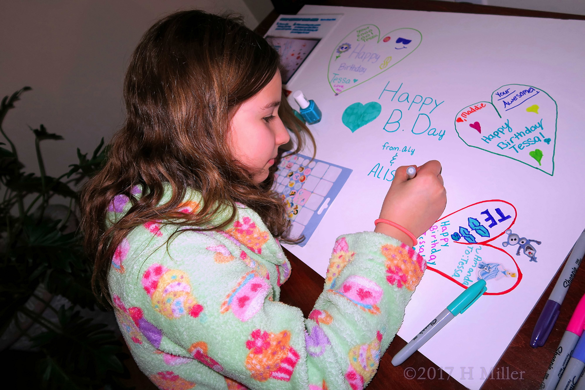 Party Guest Making Her Special Message On The Spa Birthday Card 